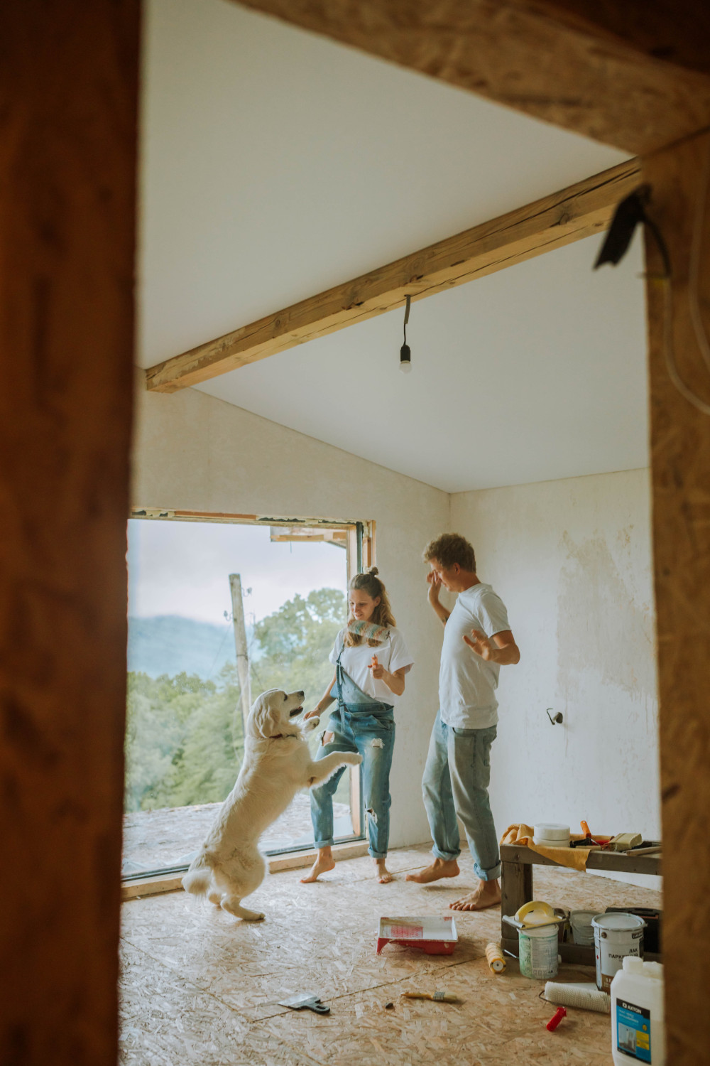 Couple and dog painting wall