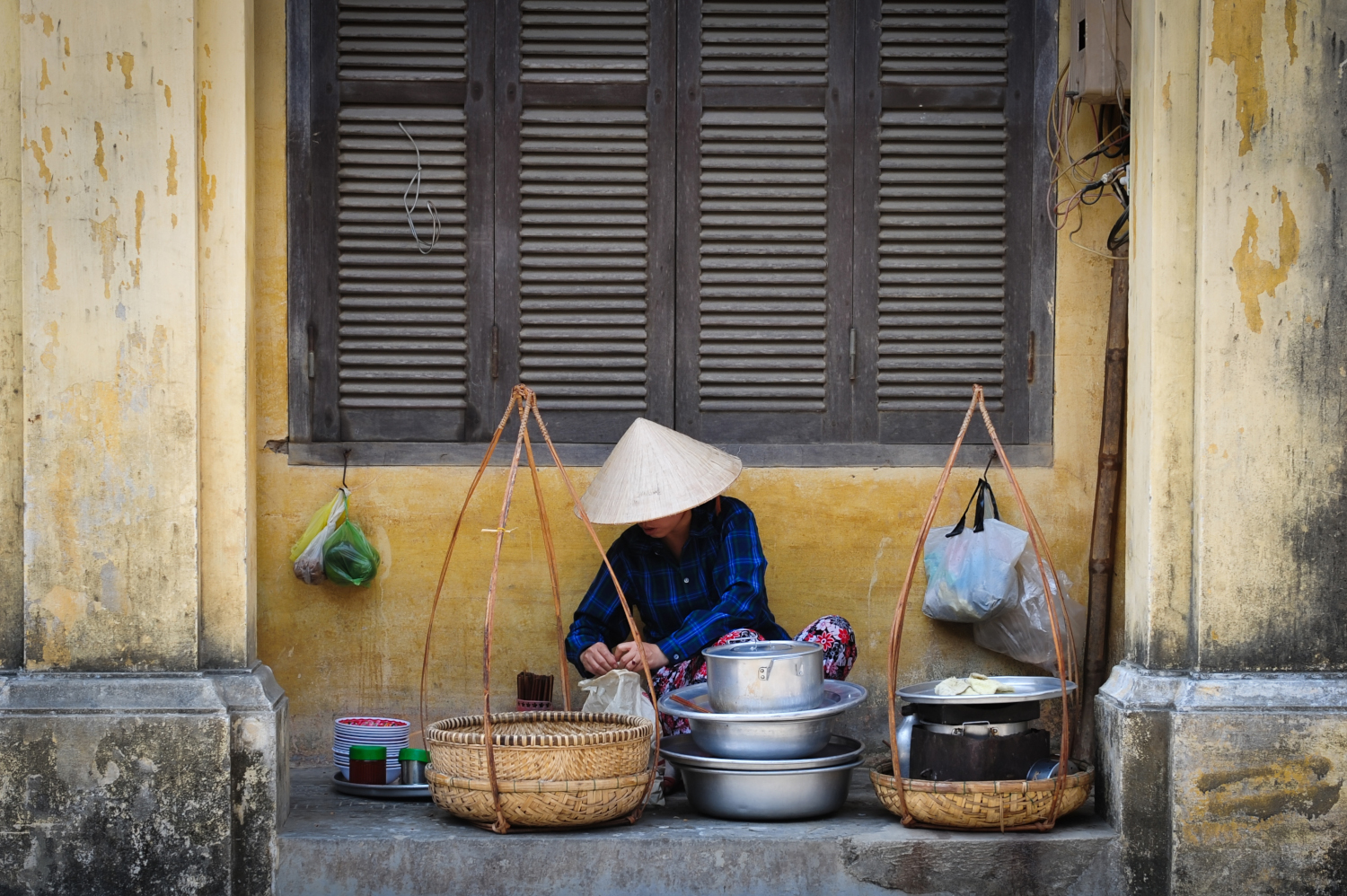 Woman selling tofu dessert with libra in Vietnam